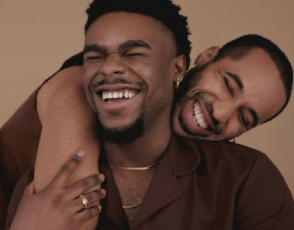 Two friends laughing and embracing